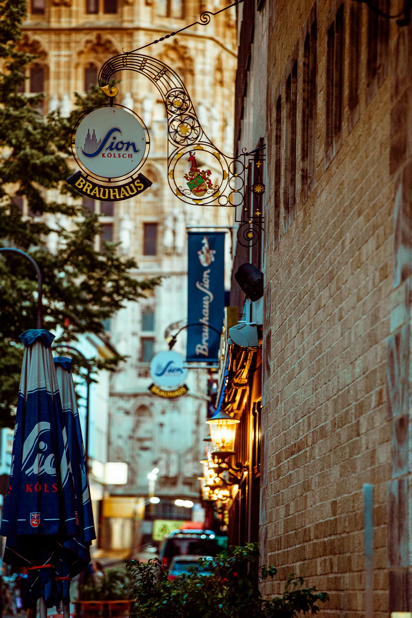 Kölsch-Kneipenschild in einer Gasse der Kölner Altstadt am Abend